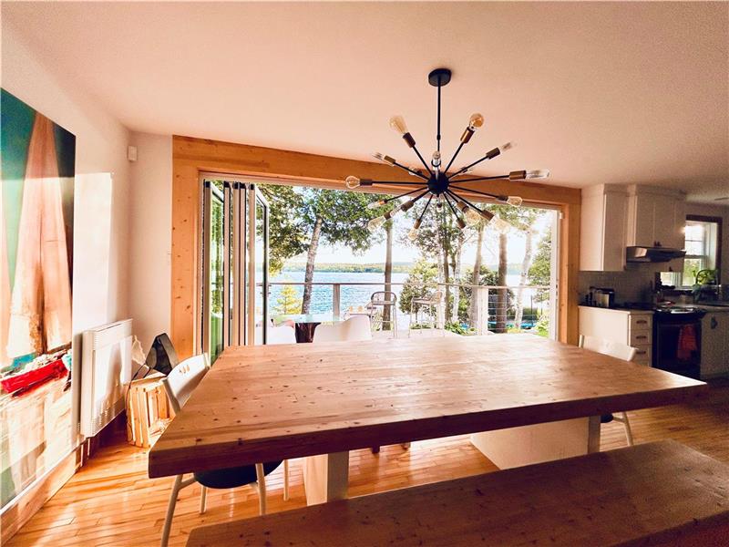 Sunny waterfront cottage with big panoramic sliding door and big dock